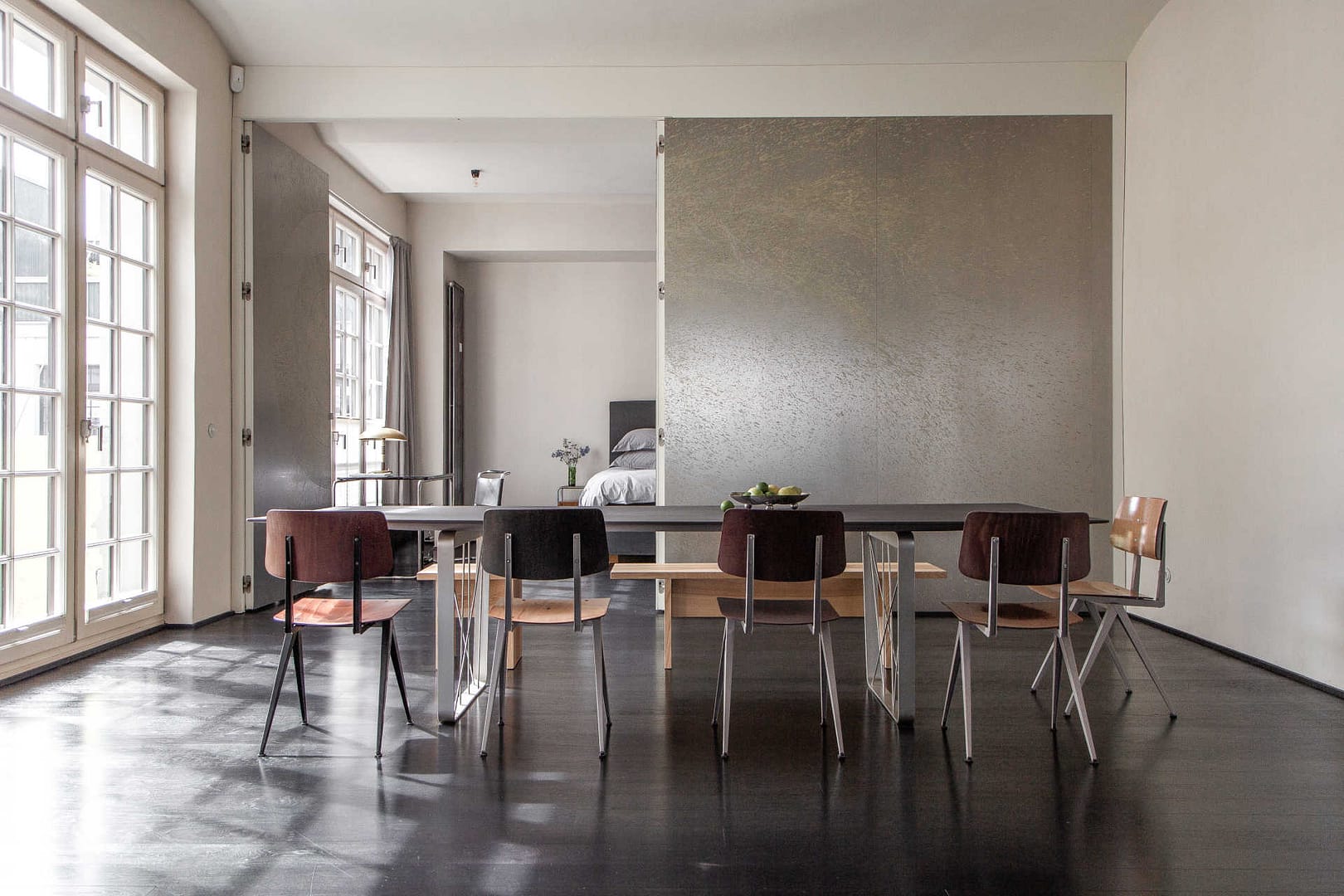 Essbereich mit Designstühlen, Wandkunst und Blick ins Schlafzimmer