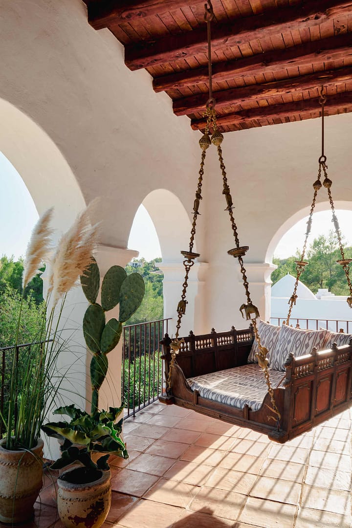 Helle Küche in einer Finca auf Ibiza mit blauer Arbeitsplatte, weißen Schränken und frischem Gemüse auf der Arbeitsfläche