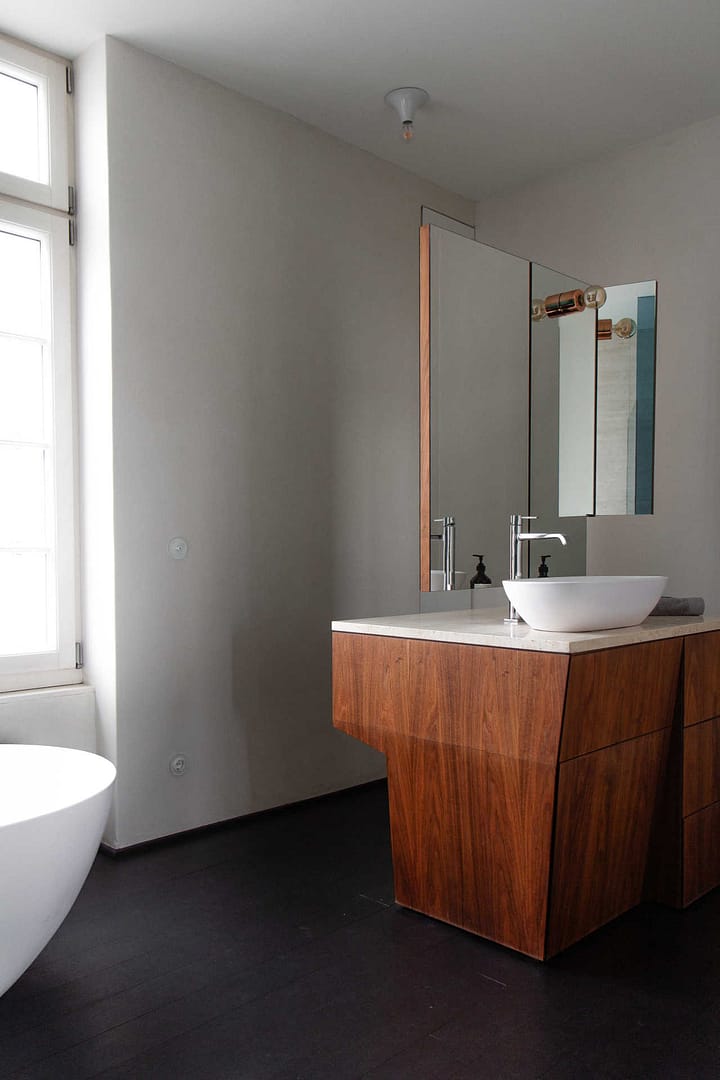 Design Apartment Berlin – Badezimmer mit freistehender Badewanne und Waschtisch aus Holz